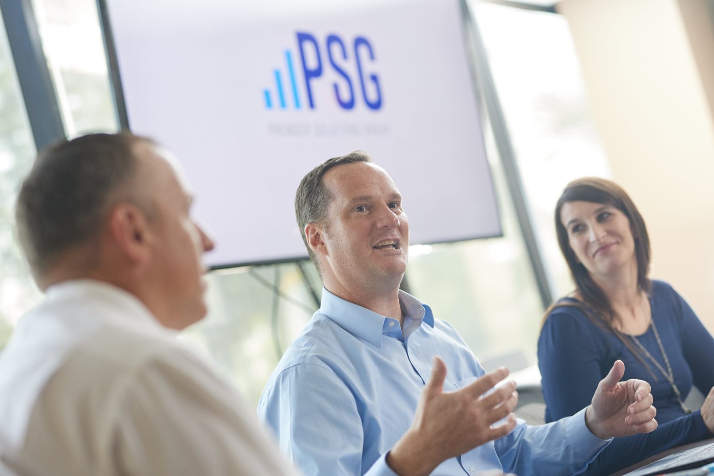 Prenger Solutions Group consultants working through Raiser's Edge reporting together at a laptop