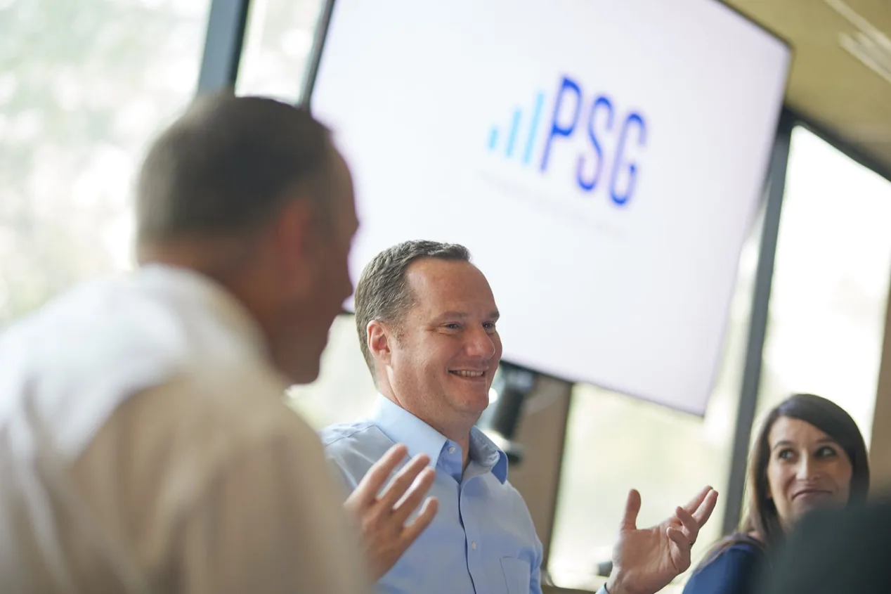A Prenger Solutions Group consultant presenting to colleagues in front of a PSG screen