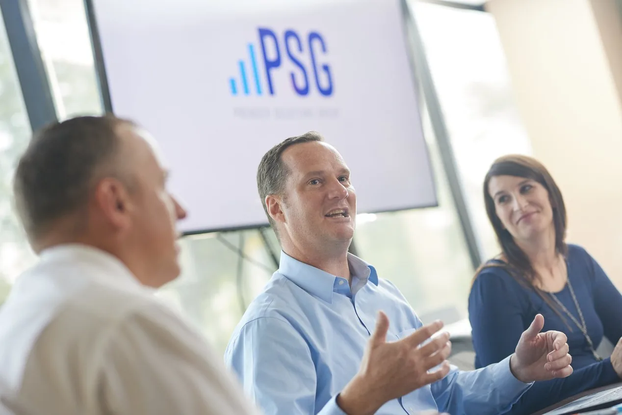 Prenger Solutions Group consultants working through Raiser's Edge reporting together at a laptop