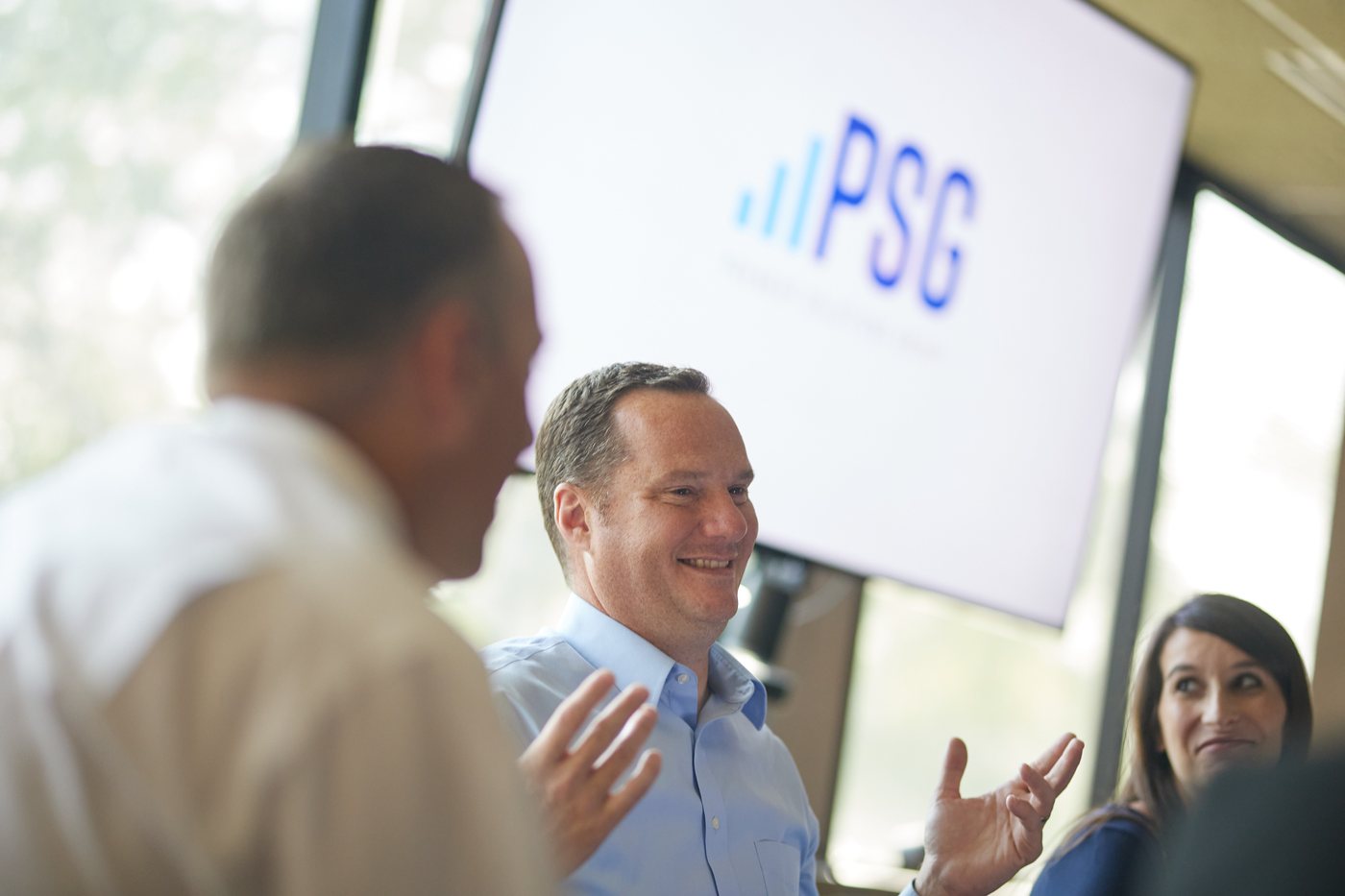 A Prenger Solutions Group consultant presenting to colleagues in front of a PSG screen