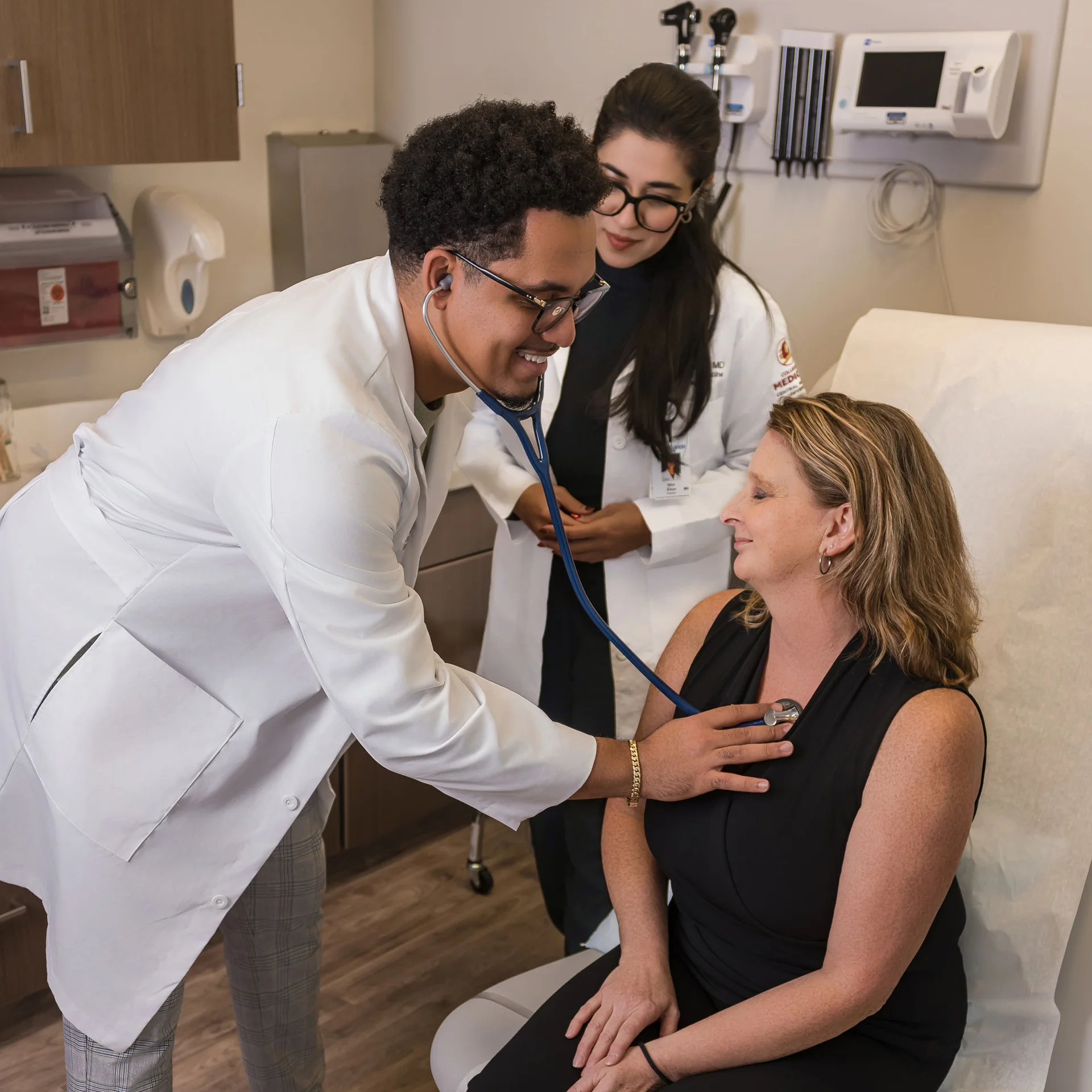 McLaren clinicians meeting with a patient in an exam room