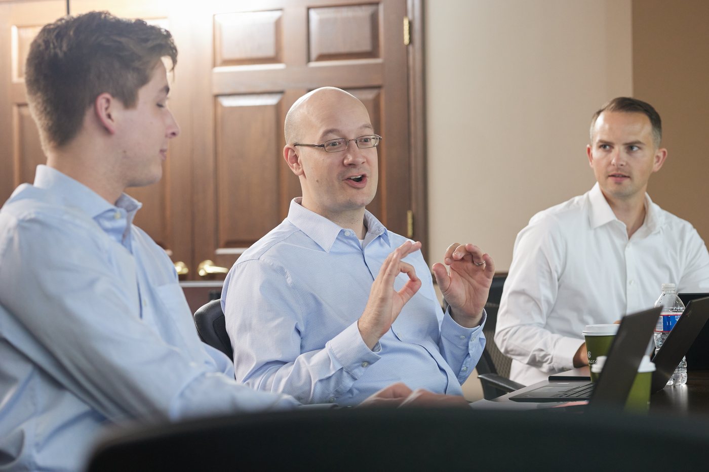 Three Prenger Solutions Group consultants reviewing pledge data together in a working session