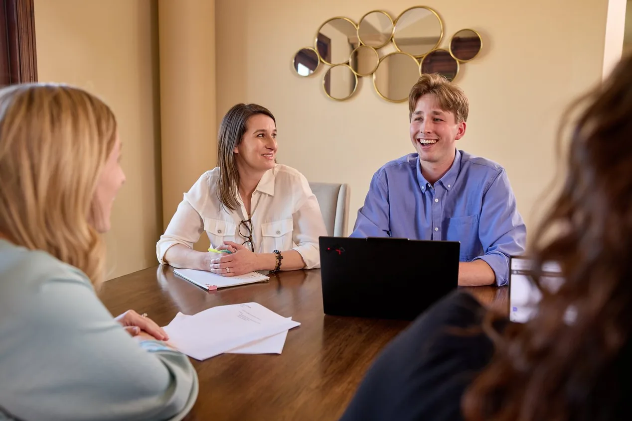 A Prenger Solutions Group working group reviewing acknowledgment materials around a table
